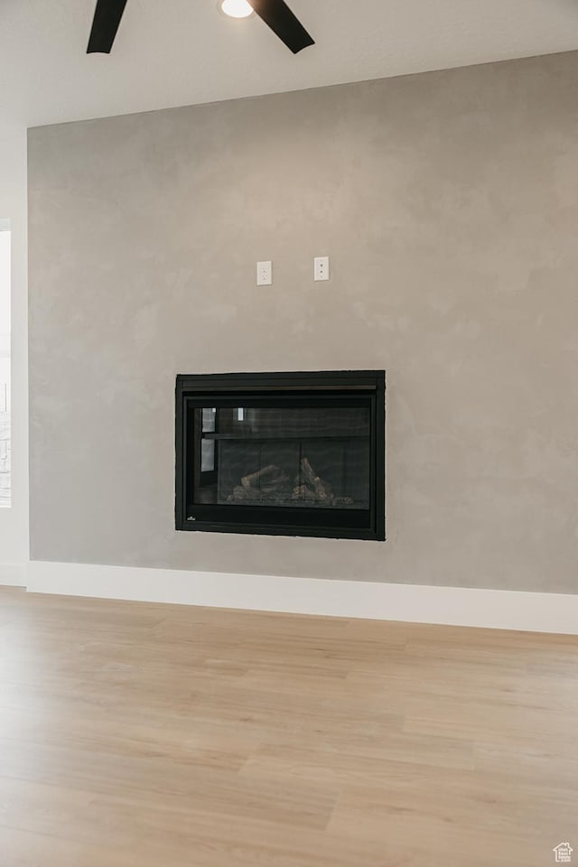 994 W Union Bench Dr S, Mapleton, UT 84664 - interior details with a glass covered fireplace, ceiling fan, baseboards, and wood finished floors