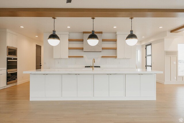 994 W Union Bench Dr S, Mapleton, UT 84664 - kitchen featuring open shelves, stainless steel microwave, light countertops, and white cabinetry