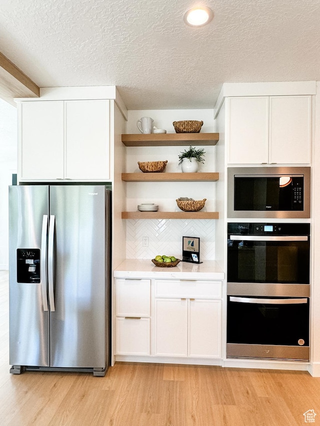 994 W Union Bench Dr S, Mapleton, UT 84664 - kitchen featuring white cabinets, light wood-style flooring, and stainless steel appliances