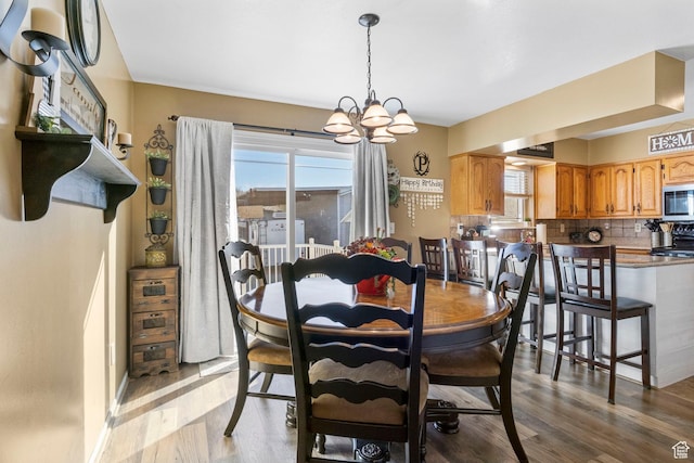 440 W Cottonwood Ln, Ferron, UT 84523 - dining room with light hardwood / wood-style flooring and a chandelier