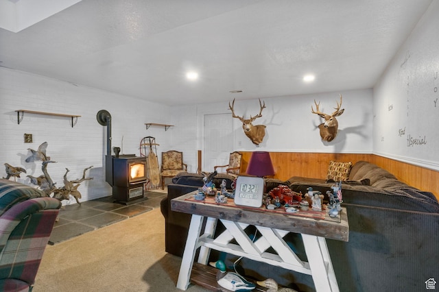 440 W Cottonwood Ln, Ferron, UT 84523 - living room featuring dark carpet, wood walls, and a wood stove