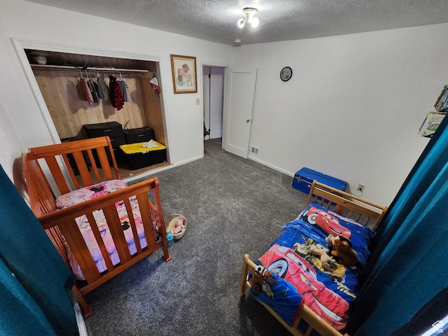 bedroom with dark carpet, a closet, and a textured ceiling