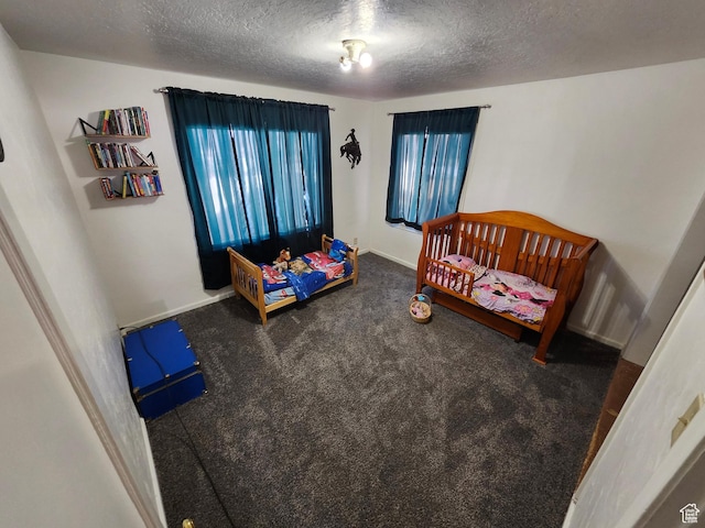 bedroom with carpet floors and a textured ceiling