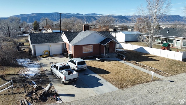 view of front facade featuring a garage and a mountain view