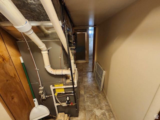 utility room with heating unit