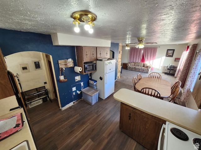 kitchen featuring ceiling fan, white electric range, dark hardwood / wood-style floors, and a textured ceiling