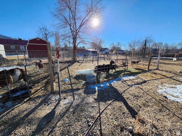 view of yard featuring an outbuilding and a rural view