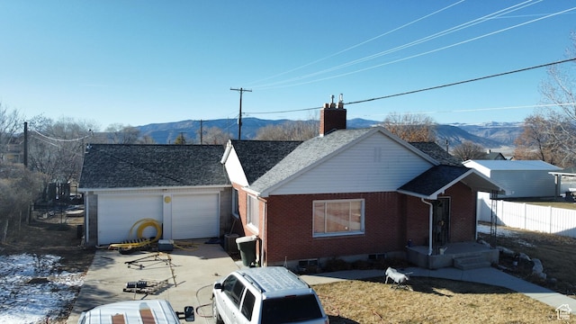 ranch-style house featuring a garage and a mountain view