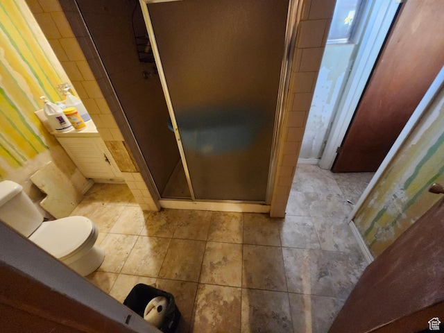 bathroom with walk in shower and toilet