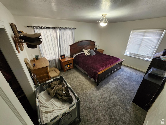 bedroom with a textured ceiling and carpet flooring