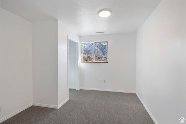 spare room with visible vents, baseboards, and carpet floors