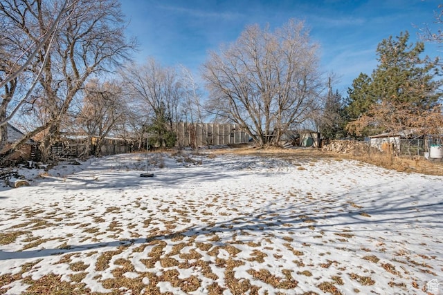 yard layered in snow with fence