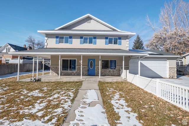 view of front facade with fence, a porch, an attached garage, stucco siding, and stone siding