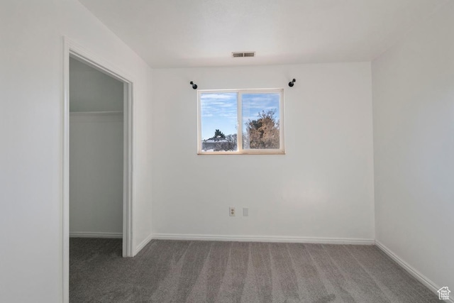 unfurnished bedroom featuring a closet, baseboards, visible vents, and carpet floors