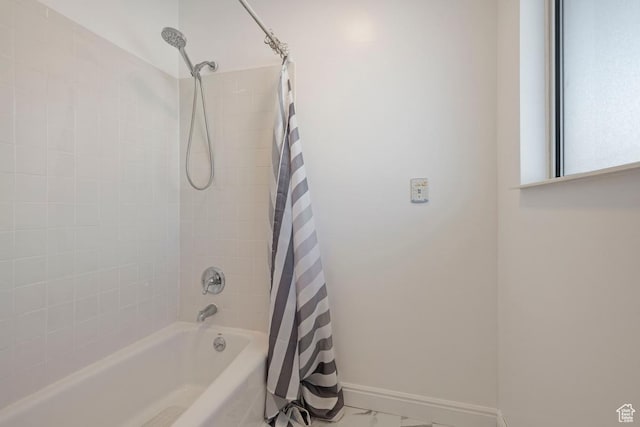 full bath featuring shower / bath combination with curtain, marble finish floor, and baseboards