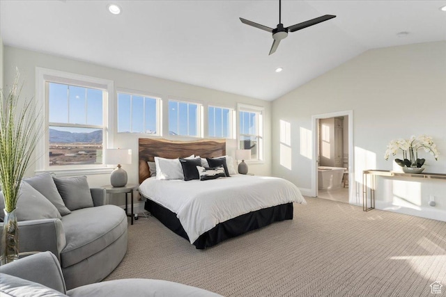 bedroom with ceiling fan, ensuite bath, vaulted ceiling, and multiple windows
