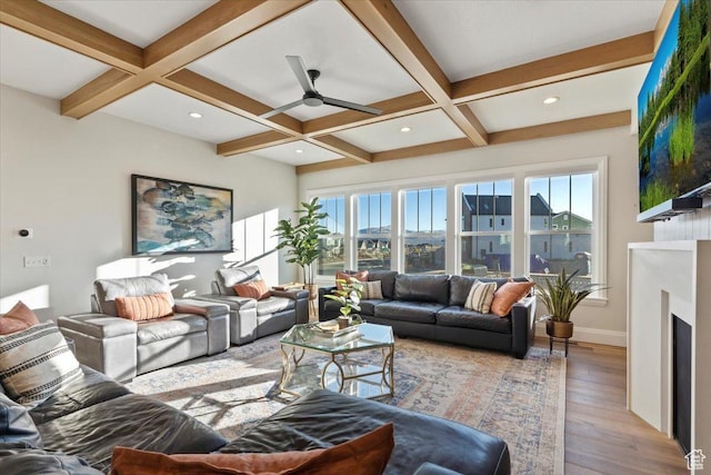 living room with coffered ceiling, hardwood / wood-style floors, beam ceiling, and ceiling fan