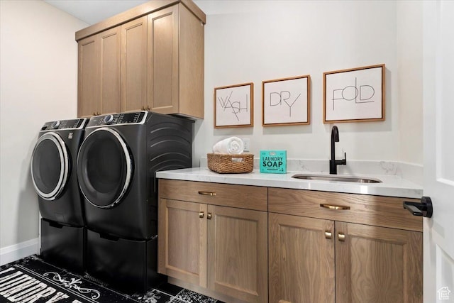 washroom featuring cabinets, separate washer and dryer, and sink
