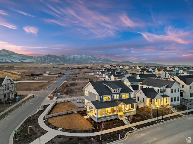 aerial view at dusk featuring a mountain view