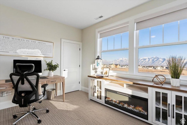 carpeted home office with a mountain view