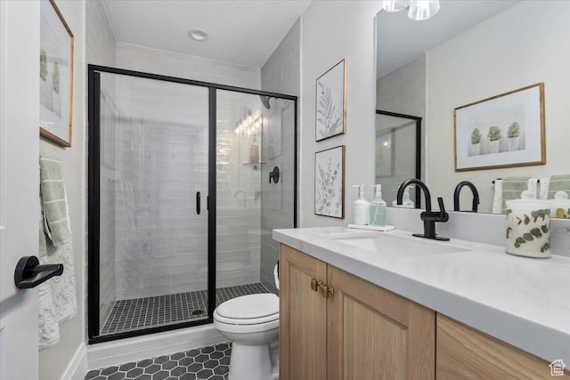 bathroom with an enclosed shower, vanity, tile patterned floors, and toilet