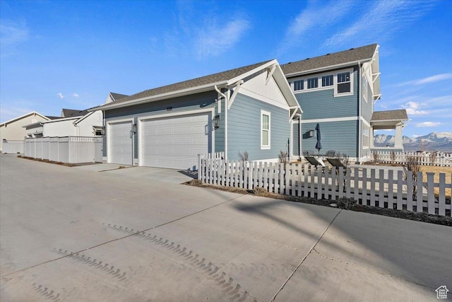 exterior space with a garage and a mountain view