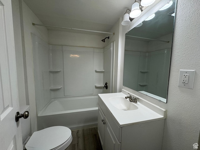 full bathroom with hardwood / wood-style flooring, vanity, bathtub / shower combination, and toilet