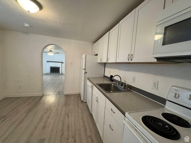 kitchen featuring sink, white cabinetry, ceiling fan, white appliances, and light hardwood / wood-style floors