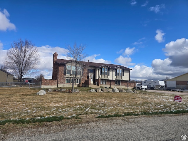 4556 W 4950 S, Hooper, UT 84315 - split foyer home featuring brick siding, fence, and a chimney