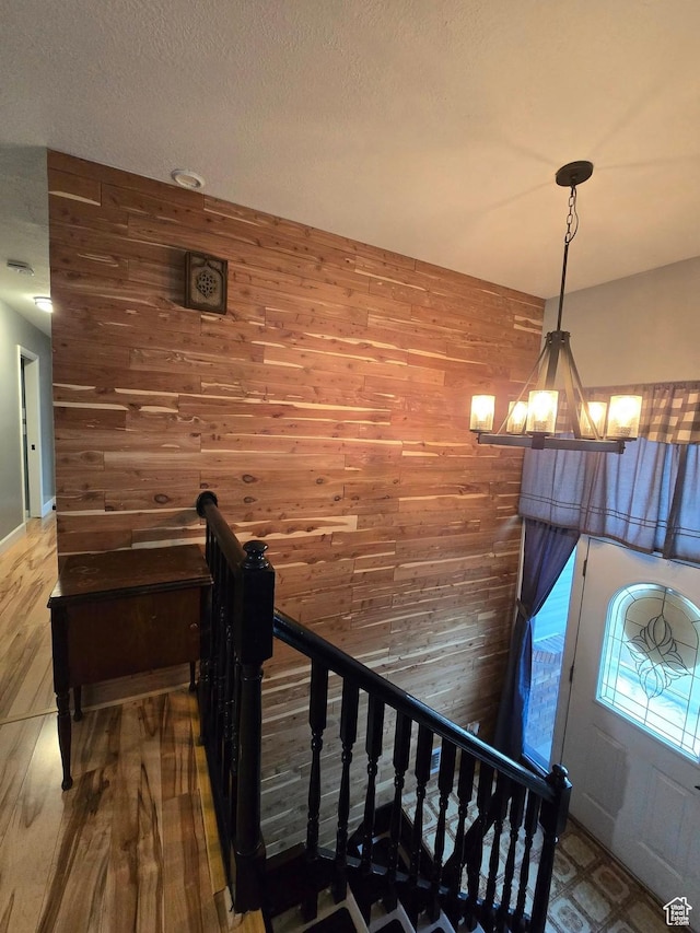 4556 W 4950 S, Hooper, UT 84315 - stairway featuring wood finished floors, wooden walls, and a notable chandelier