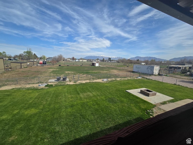 4556 W 4950 S, Hooper, UT 84315 - view of yard with fence, an outdoor structure, a mountain view, and an outdoor fire pit