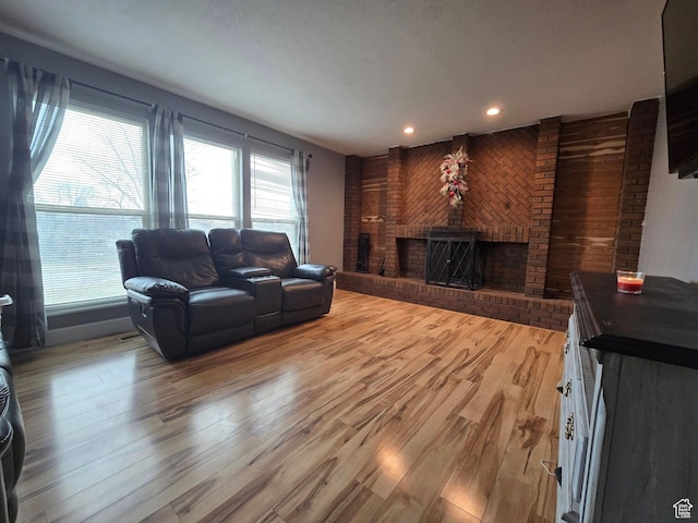 4556 W 4950 S, Hooper, UT 84315 - living area with light wood-style floors, recessed lighting, wood walls, and a brick fireplace