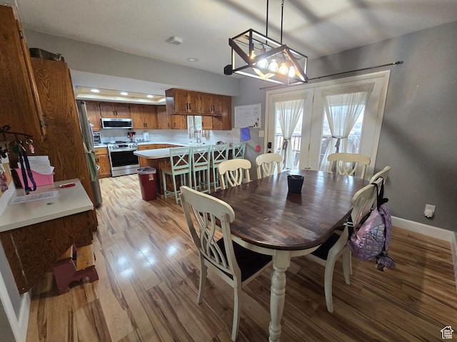 4556 W 4950 S, Hooper, UT 84315 - dining area with light wood-style floors, recessed lighting, french doors, baseboards, and a notable chandelier