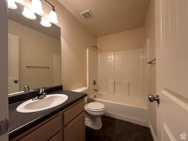 6751 S Sienna Park Ln, Midvale, UT 84047 - full bathroom with bathing tub / shower combination, vanity, a textured ceiling, tile patterned floors, and toilet