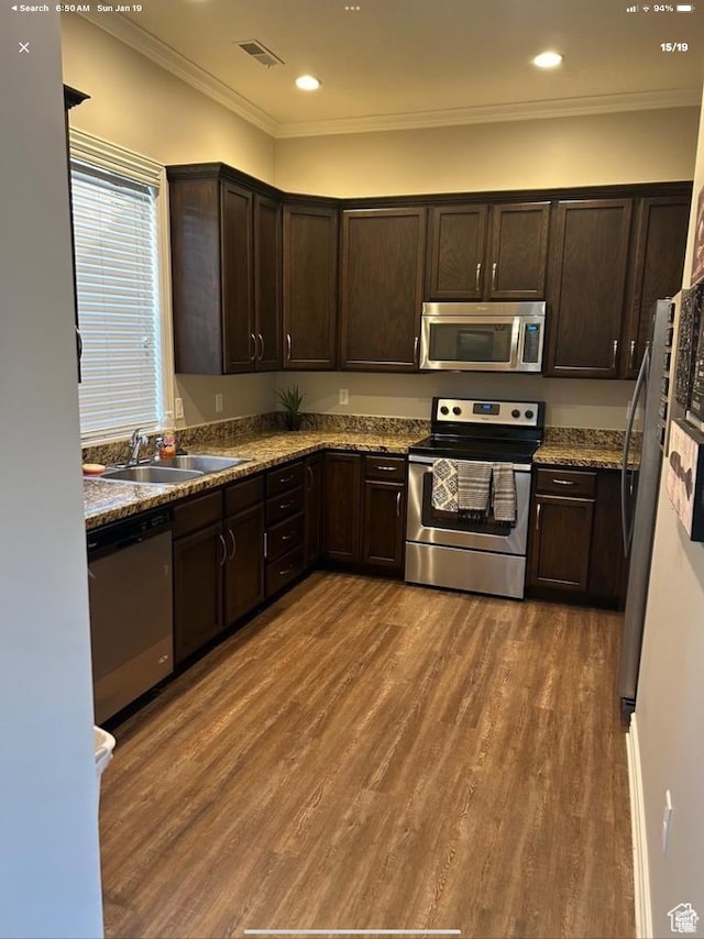 6751 S Sienna Park Ln, Midvale, UT 84047 - kitchen featuring dark wood-type flooring, dark brown cabinetry, sink, ornamental molding, and stainless steel appliances
