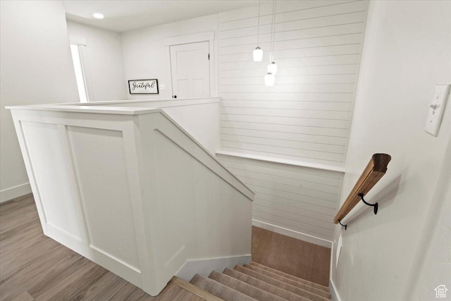 stairs with baseboards and wood finished floors