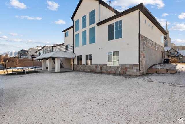 1002 W Temple Rim Ln, Payson, UT 84651 - view of property exterior featuring a trampoline, central AC unit, and a deck