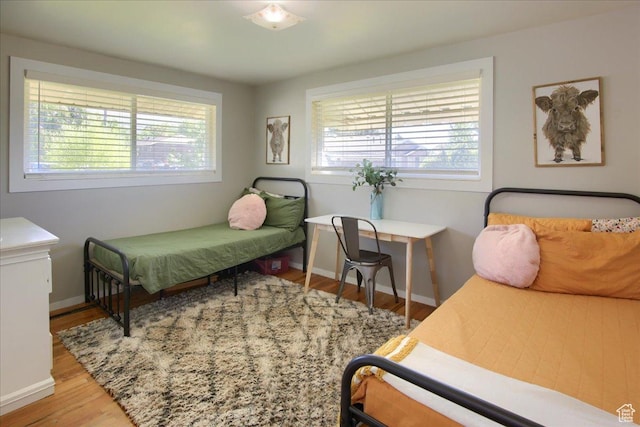 3095 N 275 E, North Ogden, UT 84414 - bedroom featuring baseboards, multiple windows, and wood finished floors