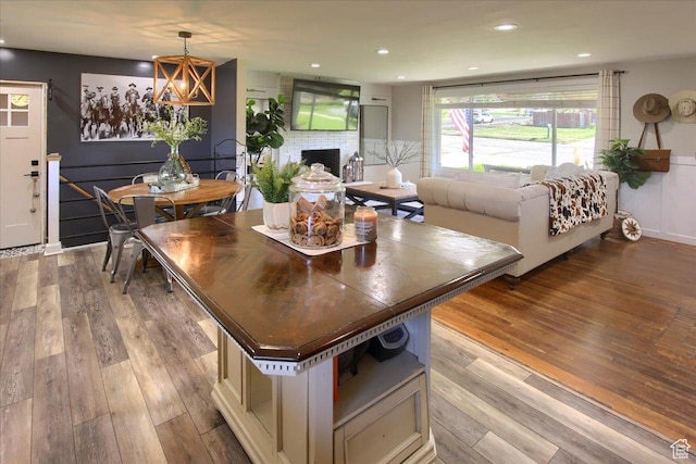 3095 N 275 E, North Ogden, UT 84414 - dining space with recessed lighting, a notable chandelier, a brick fireplace, and wood finished floors