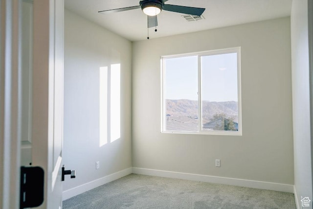 797 W 430 N, Hurricane, UT 84737 - spare room with ceiling fan, a mountain view, and light colored carpet