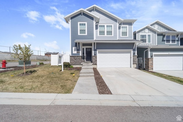 view of front of property with driveway, board and batten siding, a garage, and stone siding
