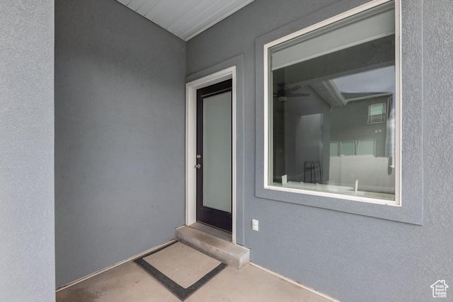 view of exterior entry featuring stucco siding