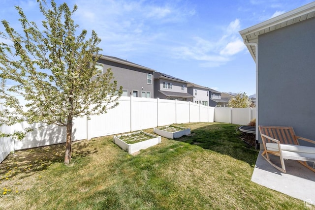 view of yard with a garden, a residential view, and fence private yard