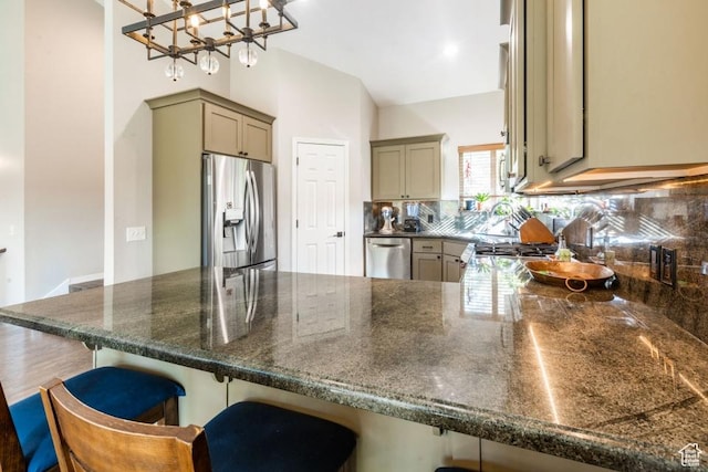 3942 View Pointe Dr, Park City, UT 84098 - kitchen with stainless steel appliances, decorative light fixtures, kitchen peninsula, and a breakfast bar area