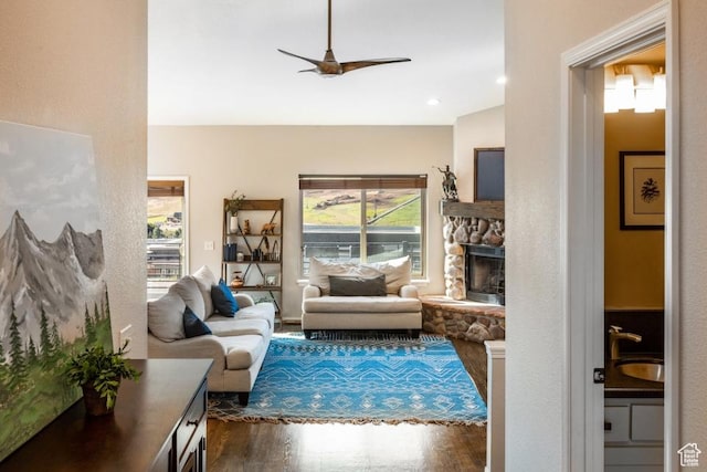 3942 View Pointe Dr, Park City, UT 84098 - living room featuring sink, a stone fireplace, dark hardwood / wood-style floors, and ceiling fan