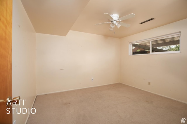 carpeted spare room with ceiling fan