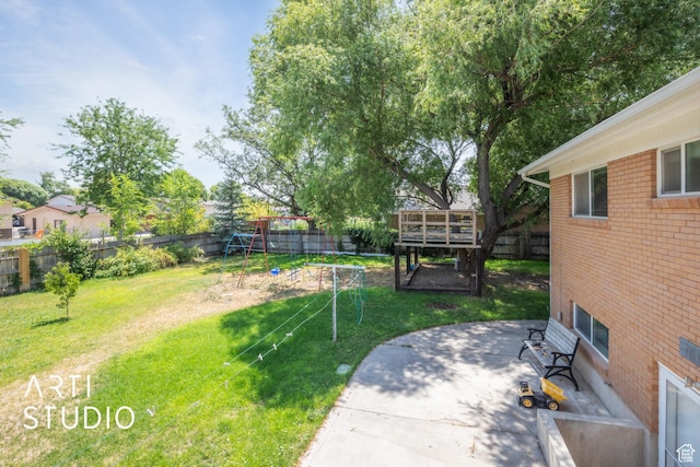 view of yard with a playground and a patio