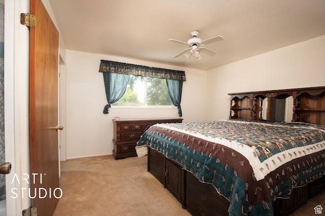 bedroom featuring light colored carpet and ceiling fan