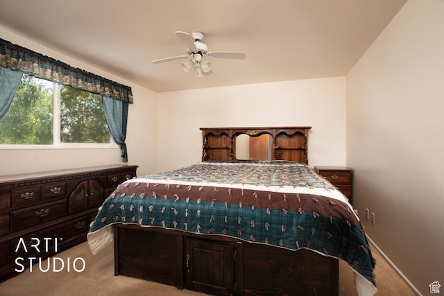 bedroom featuring light carpet and ceiling fan