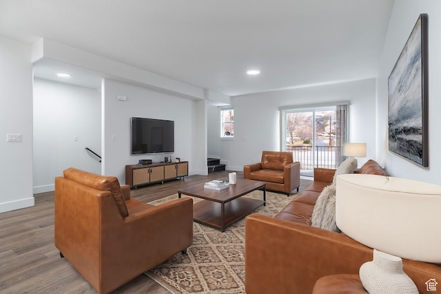 living area with recessed lighting, wood finished floors, and baseboards
